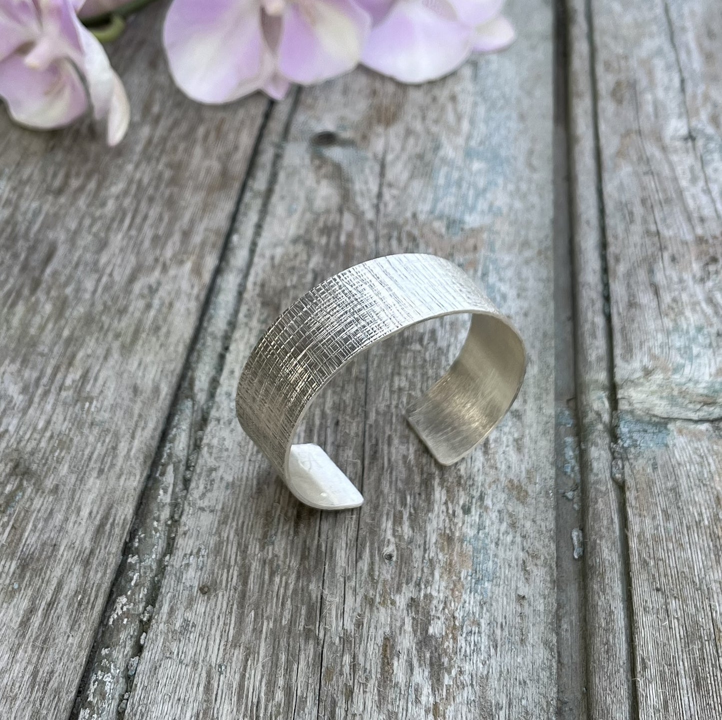 Découvrez l'élégance intemporelle du bracelet manchette en argent massif Macuxi, inspiré des traditions artisanales. Ce bracelet, fabriqué en France, arbore une texture unique, façonnée à la main. Sa conception ouverte s’adapte confortablement à tous les poignets. Un bijou durable qui incarne l'engagement pour une fabrication éthique et respectueuse de l’environnement.