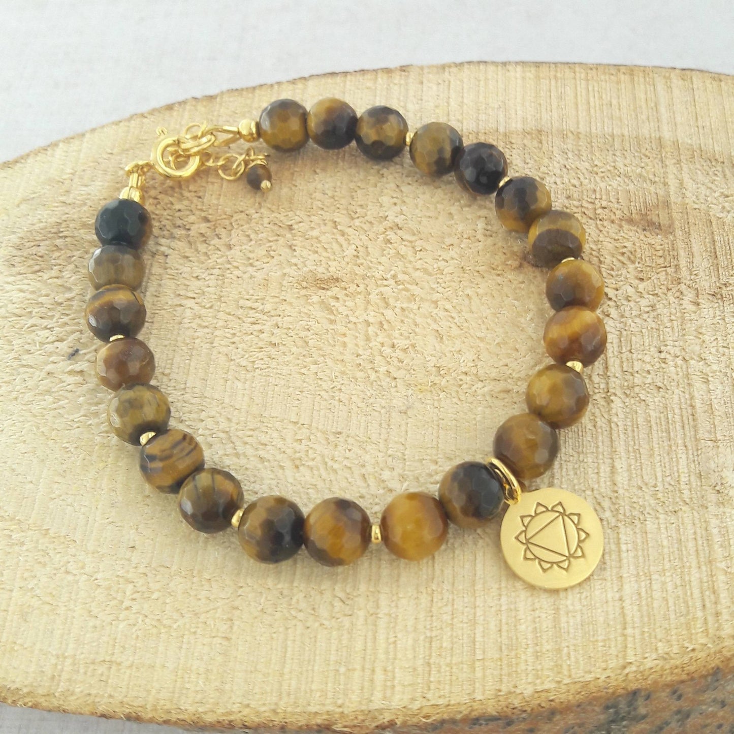 Bracelet breloque chakra Manipura en oeil de tigre et argent 925 doré. MANIPURA c’est le plexus solaire, Il est le symbole de l’estime de soi et de la puissance personnelle. Équilibré, il apportera confiance en soi, bonne humeur et ouverture aux autres.