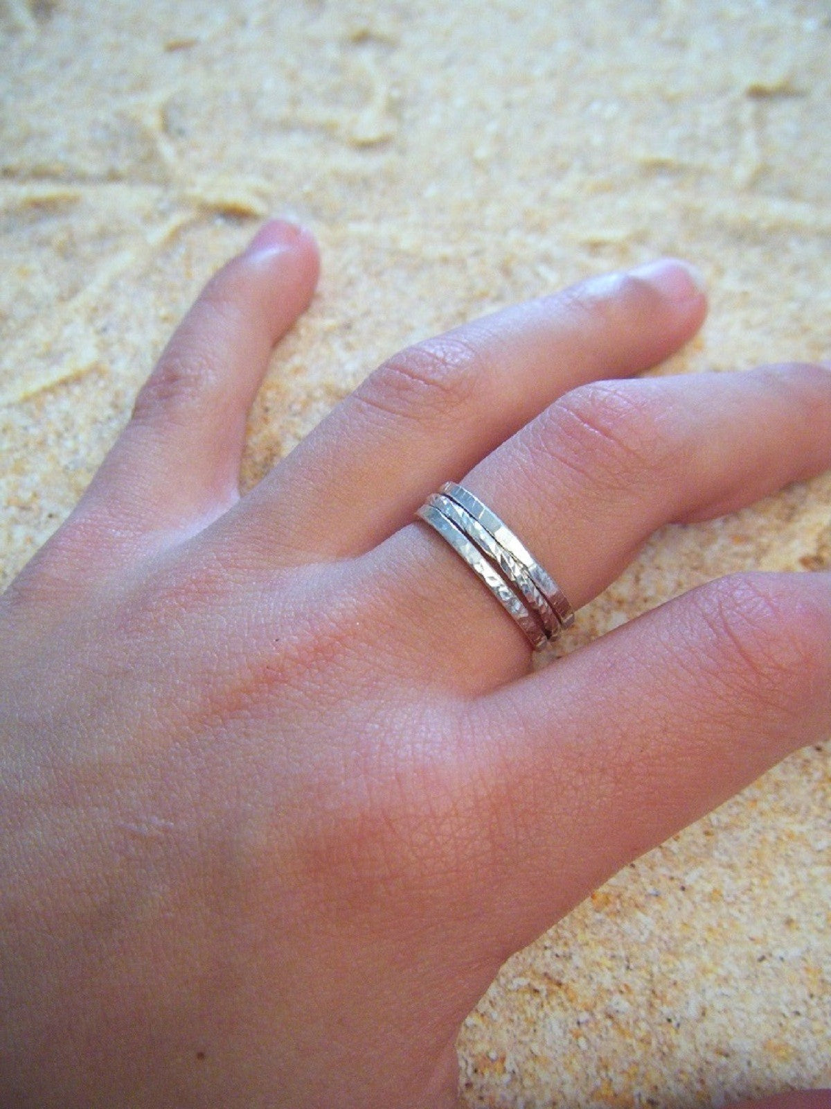 Cet ensemble de 3 bagues fines en argent massif est un mariage parfait de sophistication et de simplicité. Composé de deux bagues avec une finition martelée et d'une bague en fil torsadé, la bague Trindade offre une variété de styles pour répondre à toutes vos envies.