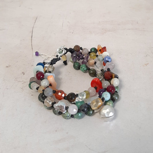 Bracelet brésilien réglable avec pierres naturelles multicolores et grelot appeleur d’anges. Un bijou bohème et spirituel, fait main.