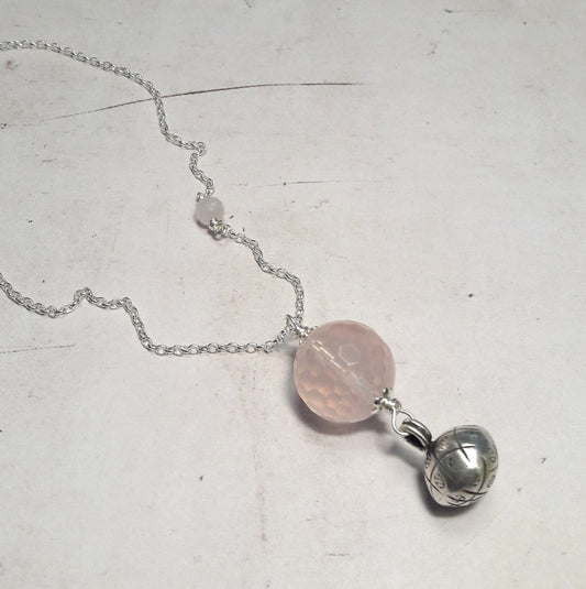 Bijoux de grossesse, sautoir bola argent 925 et pierres naturelles de quartz rose Ce sautoir est confectionné avec une chaîne en argent 925/1000, accompagnée d'un pendentif en quartz rose facetté, une pierre naturelle réputée pour ses propriétés apaisantes. Une petite cloche en argent 925/1000 ajoute une touche délicate à cet ensemble élégant et plein de sens. bijoux de grossesse, sautoir bola argent 925, cadeau femme, femme enceinte, quartz rose, bijoux pour femmes enceintes.
