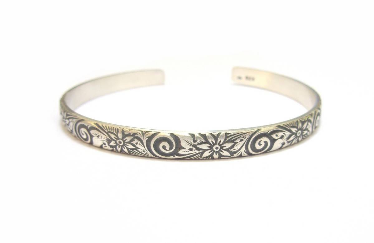 Bracelet ouvert en argent massif gravé de fleurs. Jonc réglable gravé de fleurs, pour femme.
