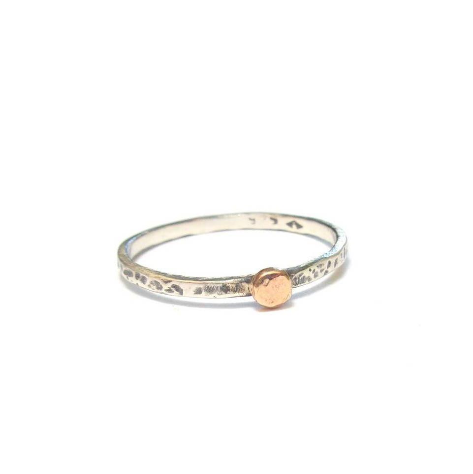 Bague fine ethnique en argent massif patiné, agrémentée d'une petite perle en or 9 carats. Son design élégant et artisanal combine l'authenticité de l'argent martelé avec l'éclat subtil de l’or, créant ainsi un bijou unique .